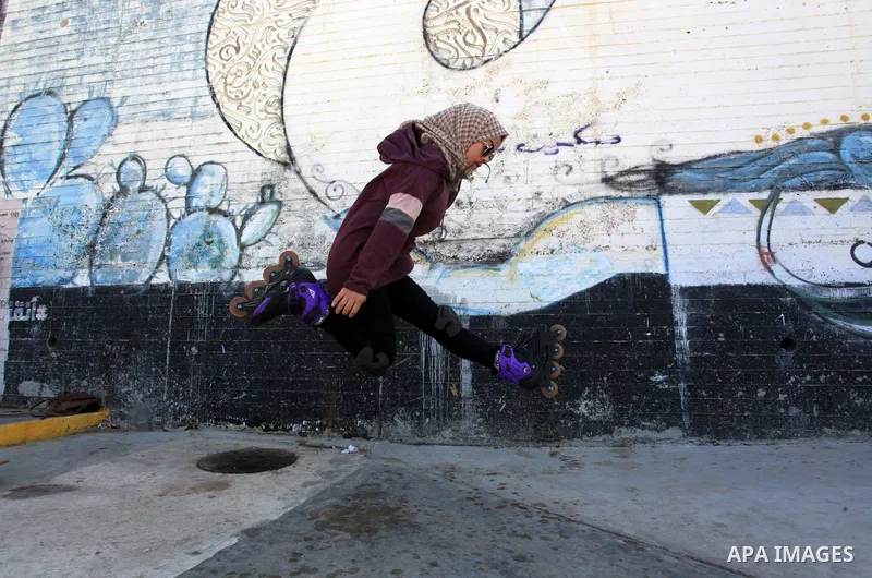 Palestinian girls practice on Skateboard sport at Gaza seaport, in Gaza city on October 27, 2021. A skateboard is a type of sports equipment used for skateboarding. They are usually made of a specially designed 7-8 ply m...