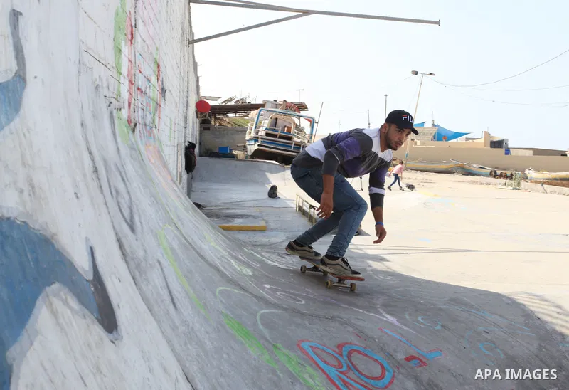 Palestinian girls practice on Skateboard sport at Gaza seaport, in Gaza city on October 27, 2021. A skateboard is a type of sports equipment used for skateboarding. They are usually made of a specially designed 7-8 ply m...