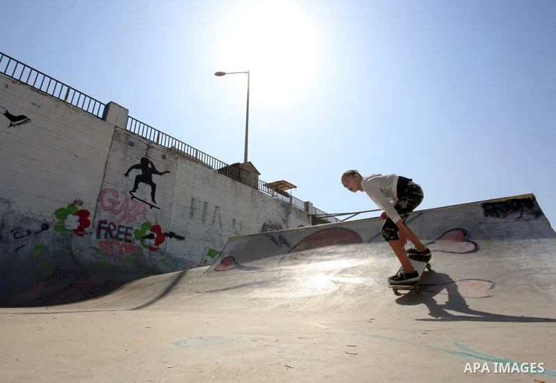 Palestinian girls practice on Skateboard sport at Gaza seaport, in Gaza city on October 27, 2021. A skateboard is a type of sports equipment used for skateboarding. They are usually made of a specially designed 7-8 ply m...