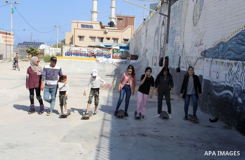 Palestinian girls practice on Skateboard sport at Gaza seaport, in Gaza city on October 27, 2021. A skateboard is a type of sports equipment used for skateboarding. They are usually made of a specially designed 7-8 ply m...