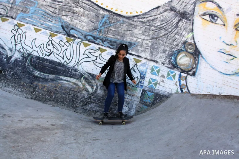 Palestinian girls practice on Skateboard sport at Gaza seaport, in Gaza city on October 27, 2021. A skateboard is a type of sports equipment used for skateboarding. They are usually made of a specially designed 7-8 ply m...