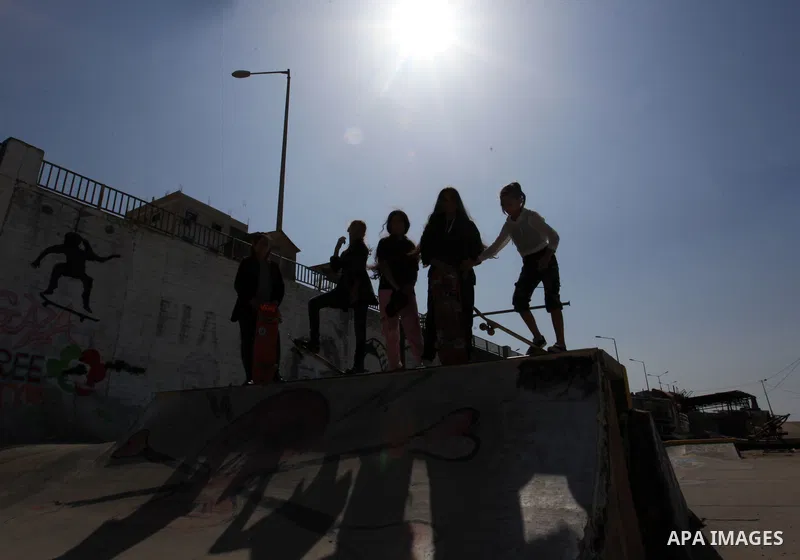 Palestinian girls practice on Skateboard sport at Gaza seaport, in Gaza city on October 27, 2021. A skateboard is a type of sports equipment used for skateboarding. They are usually made of a specially designed 7-8 ply m...