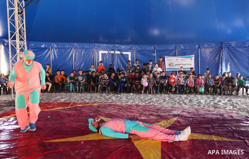 Palestinian children attend a circus performance inside a circus tent, in Beit Hanoun in the nothern Gaza Strip on October 28, 2021. The Gaza Stars School was established in an area of one dunam (1,000 square metres) and...