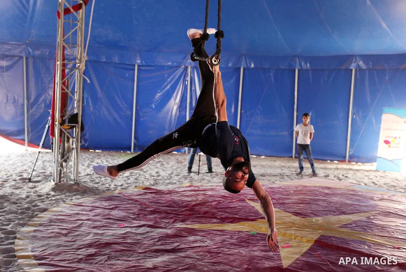 Palestinian children attend a circus performance inside a circus tent, in Beit Hanoun in the nothern Gaza Strip on October 28, 2021. The Gaza Stars School was established in an area of one dunam (1,000 square metres) and...