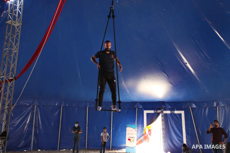 Palestinian children attend a circus performance inside a circus tent, in Beit Hanoun in the nothern Gaza Strip on October 28, 2021. The Gaza Stars School was established in an area of one dunam (1,000 square metres) and...