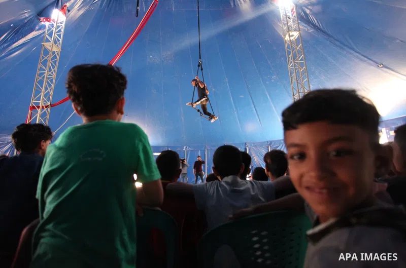 Palestinian children attend a circus performance inside a circus tent, in Beit Hanoun in the nothern Gaza Strip on October 28, 2021. The Gaza Stars School was established in an area of one dunam (1,000 square metres) and...