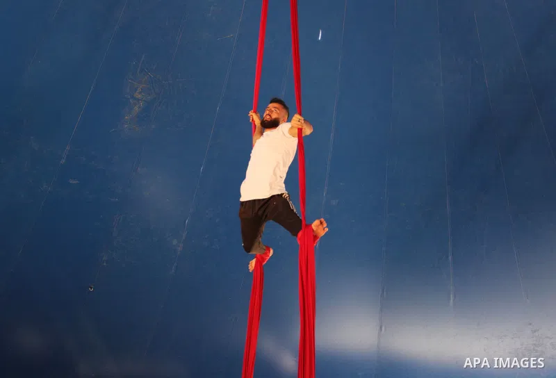 Palestinian children attend a circus performance inside a circus tent, in Beit Hanoun in the nothern Gaza Strip on October 28, 2021. The Gaza Stars School was established in an area of one dunam (1,000 square metres) and...