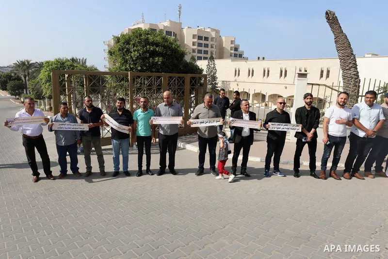 Employees of the Palestinian Authority whose salaries have been cut participate in a protest to demand the return of their salaries in front of the European Union headquarters in Gaza city on October 28, 2021. Photo by R...