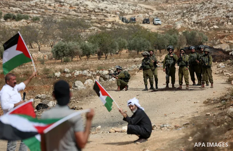 Palestinian protesters clash with Israeli forces during a protest against Israeli settlements, in Beit Dajan, in the West Bank city of Nablus on October 29, 2021. Photo by Stringer