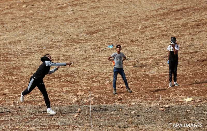 Palestinian protesters clash with Israeli forces during a protest against Israeli settlements, in Beit Dajan, in the West Bank city of Nablus on October 29, 2021. Photo by Stringer