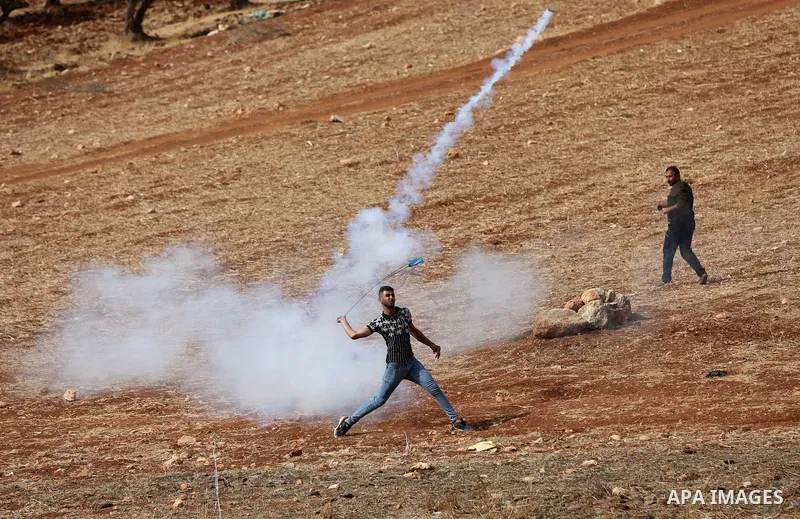 Palestinian protesters clash with Israeli forces during a protest against Israeli settlements, in Beit Dajan, in the West Bank city of Nablus on October 29, 2021. Photo by Stringer