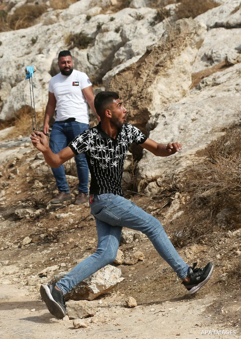 Palestinian protesters clash with Israeli forces during a protest against Israeli settlements, in Beit Dajan, in the West Bank city of Nablus on October 29, 2021. Photo by Stringer