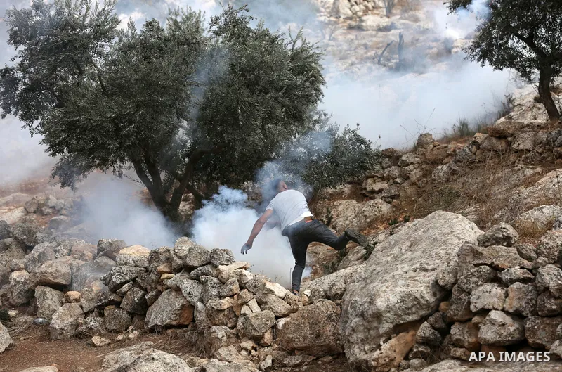 Palestinian protesters clash with Israeli forces during a protest against Israeli settlements, in Beit Dajan, in the West Bank city of Nablus on October 29, 2021. Photo by Stringer