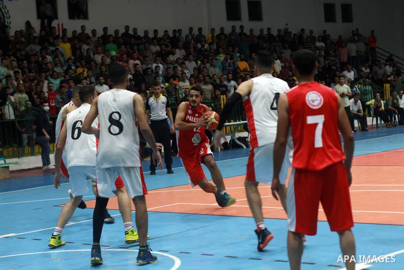 Palestinian basketball players of Khadamat al-Burij club and khadamat Maghazi compete during league, in Gaza City on October 30, 2021. Photo by Ali Hamad