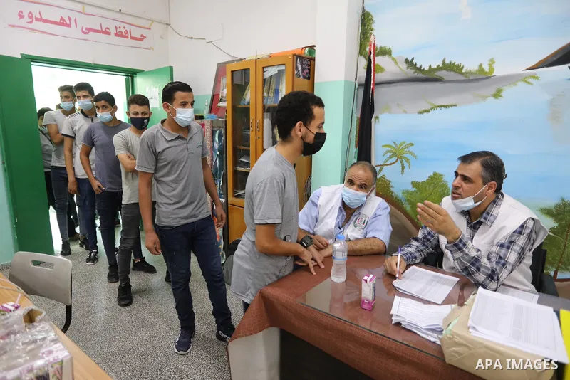 Palestinian students get inoculated with a dose of the Covishield vaccine against the Covid-19 coronavirus, at a school, in Nuseirat refugee camp in central Gaza Strip, on September 1, 2021. Palestinian health authoritie...