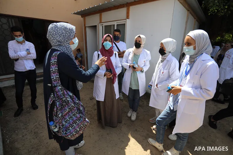 Palestinian medicals and activists participate during the "Awareness Bus" initiative to educate people about the Corona vaccine in poor areas, in Beit Lahia in the northern of Gaza Strip on September 2, 2021. Photo by As...