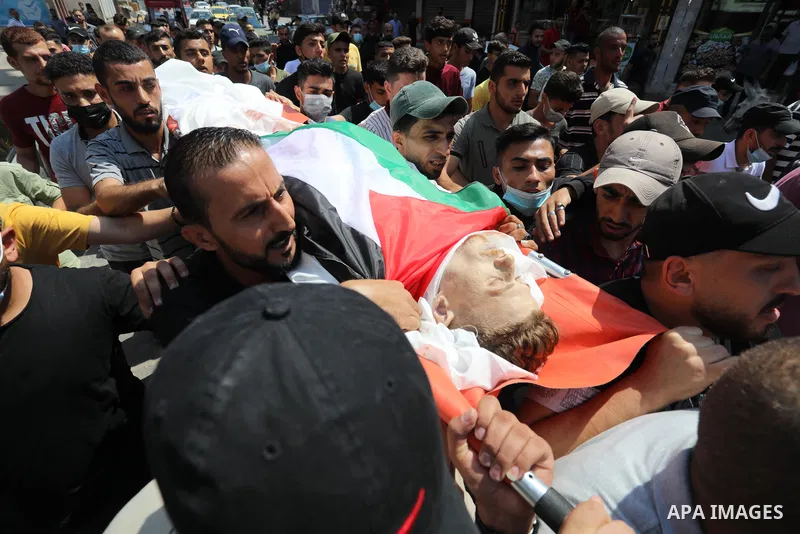 Mourners attend the funeral of Palestinian Ahmed Saleh, who was shot dead by Israeli troops during night clashes the Israeli-Gaza border fence, at Jabalia refugee camp northern Gaza Strip on September 3, 2021. Photo by A...