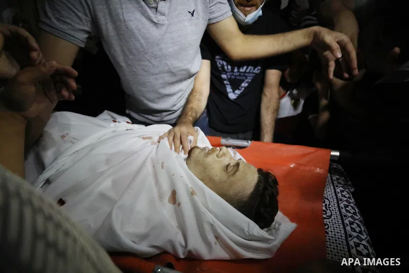 Mourners attend the funeral of Palestinian Ahmed Saleh, who was shot dead by Israeli troops during night clashes the Israeli-Gaza border fence, at Jabalia refugee camp northern Gaza Strip on September 3, 2021. Photo by A...