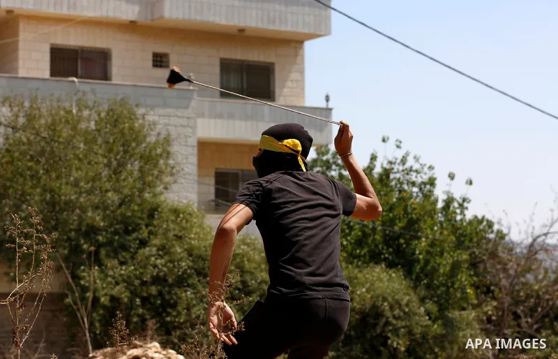 Palestinian protesters clash with Israeli forces following a weekly demonstration against Israeli settlement in the West Bank village of Kfar Qaddum, on September 3, 2021. Photo by Stringer