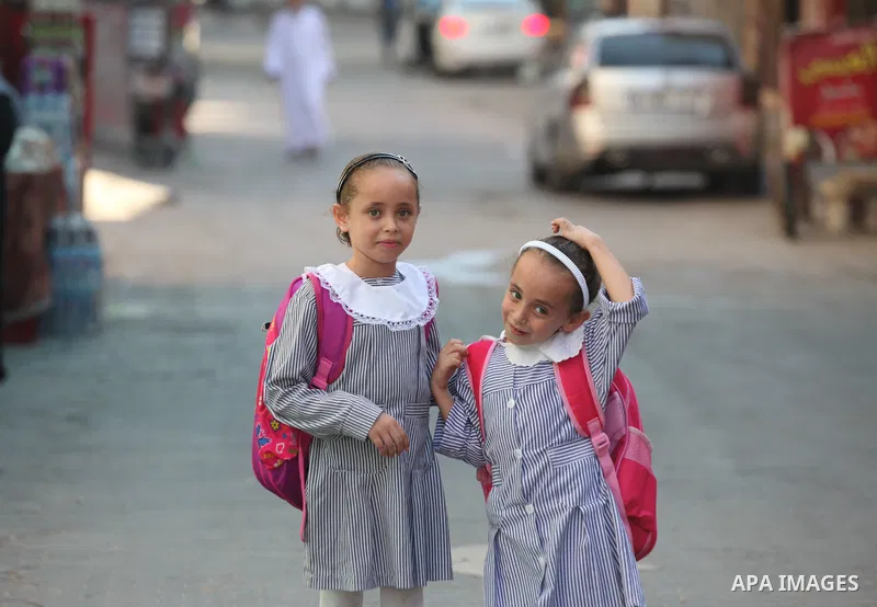 Palestinian school girls pose for a photo in al-Shati refugee camp, west of Gaza City, on September 5, 2021. Over the last 14 years, Gaza residents have endured four deadly Israeli attacks, rebuilding after each one and...