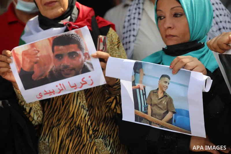Palestinians celebrate after the escape of Six Palestinian prisoners, in front of Red Cross office in Gaza city, on Sebtember 6, 2021. ​Six Palestinian prisoners, most of them serving life term for resisting the Israeli...