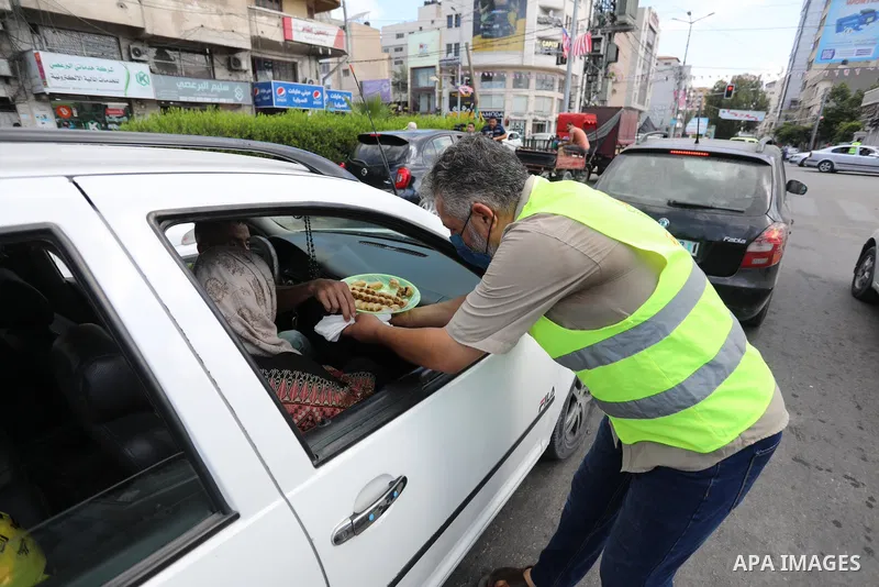 Palestinians distribute sweets after the escape of Six Palestinian prisoners, in Gaza city, on Sebtember 6, 2021. Six Palestinian prisoners, most of them serving life term for resisting the Israeli occupation, broke out...