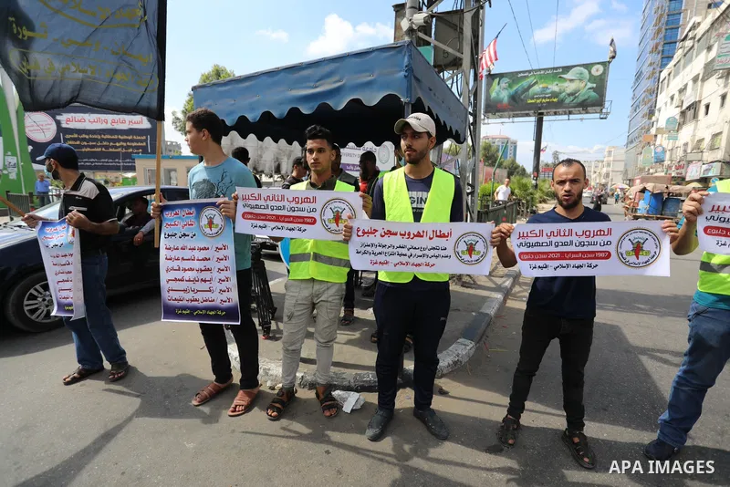 Palestinians distribute sweets after the escape of Six Palestinian prisoners, in Gaza city, on Sebtember 6, 2021. Six Palestinian prisoners, most of them serving life term for resisting the Israeli occupation, broke out...