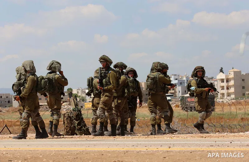 Israeli soldiers search Palestinian labourers, who works in Israel, before allowing them to cross through a hole in a security fence in the West Bank town of Jenin, on September 6, 2021, following the break out of six Pa...