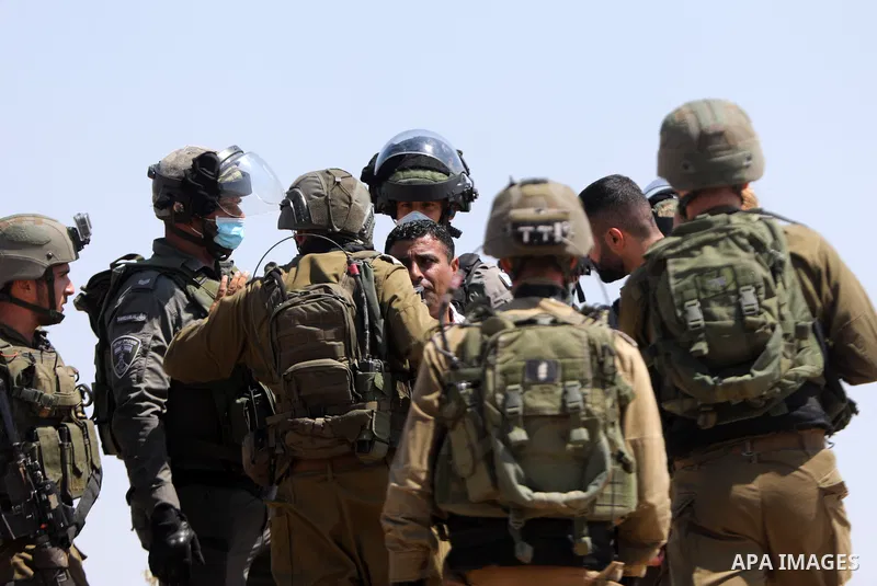 Israeli soldiers detain a Palestinian demonstrator during a protest by Palestinian land-owners against confiscation of lands by Israel near the settlement of Ma'aon, by the Palestinian village of Yatta south of Hebron in...