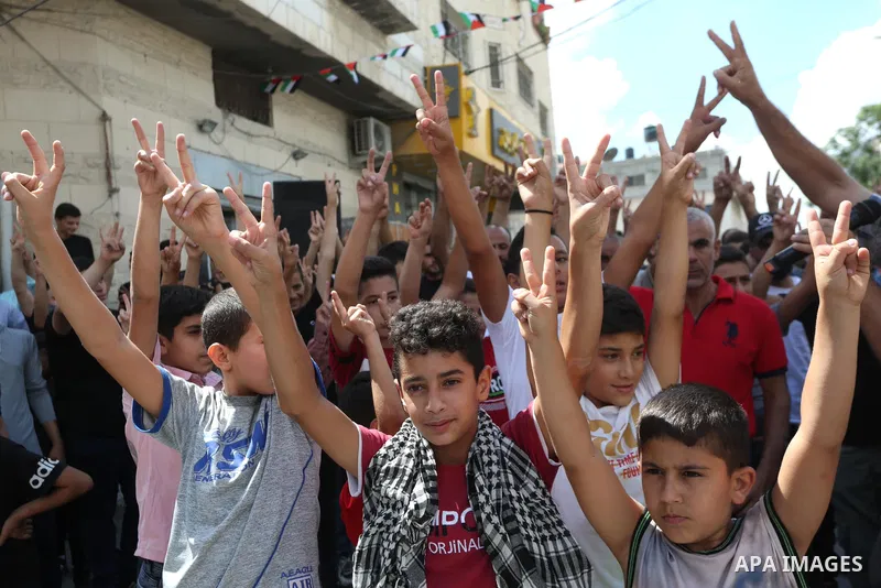Palestinians chant slogans during a protest against prisoners who were arrested following their escape from Gilboa prison, in the West Bank city of Jenin on 11 Sebtember 2021. Two more of the six Gilboa prison freedom fi...