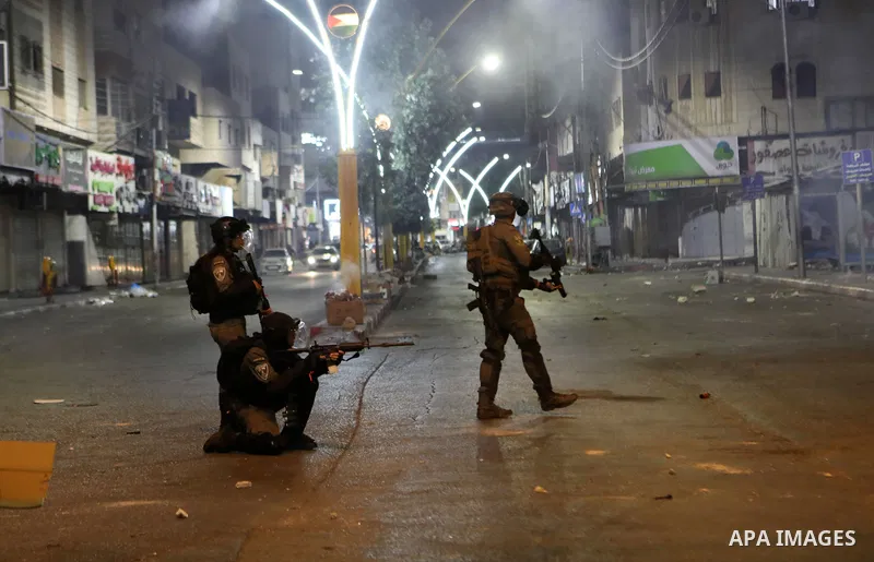 Israeli security forces take position during clashes with Palestinian protesters following a rally in support of Palestinian prisoners held in Israeli jails, in the West Bank city of Hebron, on September 11, 2021.Two mor...