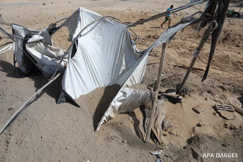Palestinians inspect the site of an Israeli airstrike following the Palestinian rocket fire into Israel, in Deir al-Balah city in the central Gaza Strip, on September 13, 2021. For the third night in a row, Israeli warpl...
