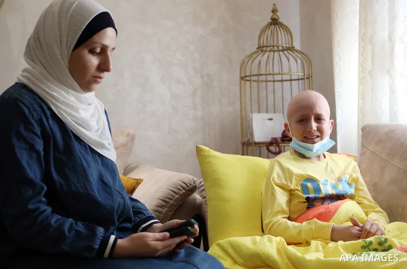 A Palestinian cancer-stricken child, Ahmad Qawasmeh, who Israeli forces detained his father, sits inside his family home in the West Bank city of Hebron on 16, 2021. Israeli forces detained 37-year-old father-of-four, Hi...