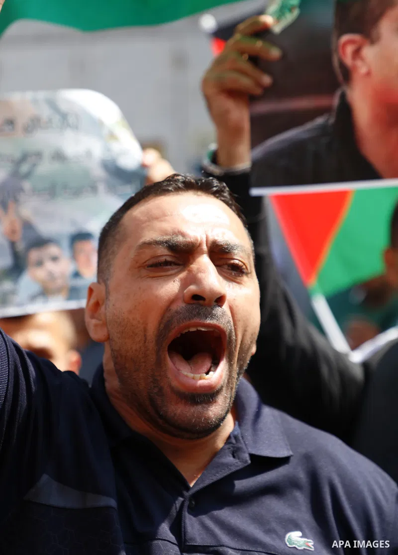 Palestinians take part in a protest to solidarity with prisoners in Israeli Jalis, in front of Red Cross office, in the West Bank city of Jenin, on September 14, 2021. The Palestinian prisoners’ movement announced that 1...