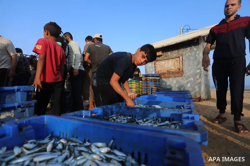 Palestinian fishermen work on the shore of the Mediterranean Sea, in Deir El-Balah, in the center of Gaza strip, on September 21, 2021. Fishing is a major source of revenue for the impoverished Palestinian enclave. Israe...