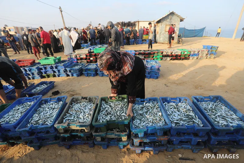 Palestinian fishermen work on the shore of the Mediterranean Sea, in Deir El-Balah, in the center of Gaza strip, on September 21, 2021. Fishing is a major source of revenue for the impoverished Palestinian enclave. Israe...