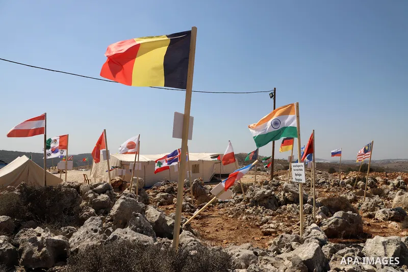 Palestinian activists raise the flags of nations, that oppose illegal settlements at the newly erected camp dubbed the United Nations camp, near the Israeli settlement of Ariel, west of West Bank town of Salfit on Septem...