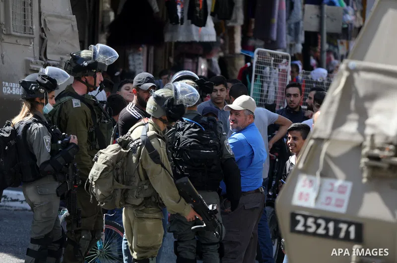 Israeli forces stand guard as groups of Israeli Ultra Orthodox Jews on their way to visit the tomb of Othniel Ben Kenaz in an Arab neighbourhood of the divided West Bank city of Hebron on September 22, 2021. Photo by Mam...