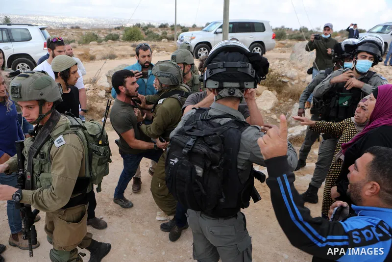 Israeli security forces scuffle with Jewish settlers from the settlement of Susya as they try to attack Palestinians from the village of the same name, during the visit of a group of representatives of the European Union...