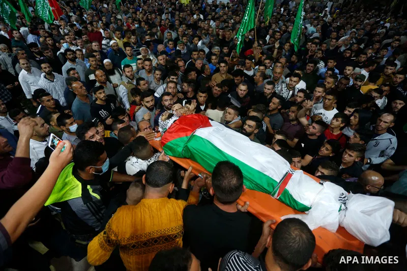 Mourners attend the funeral of Mohammed Khabisa, a Palestinian who was shot dead by Israeli troops, in the West Bank village of Beita, on September 24, 2021. A Palestinian was shot dead by Israeli troops when clashes bro...