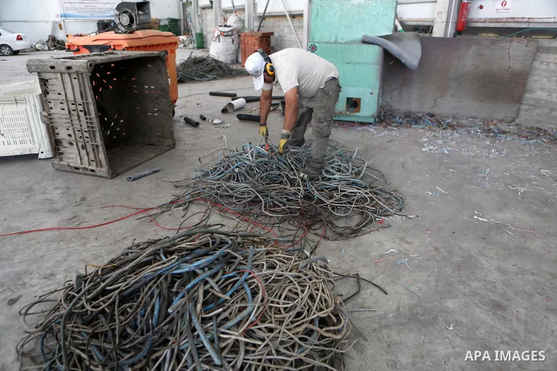 Palestinian workers reuse electronic waste it using modern, environmentally friendly scientific methods at a factory, in the West Bank city of Hebron, on September 25, 2021. Photo by Mamoun Wazwaz