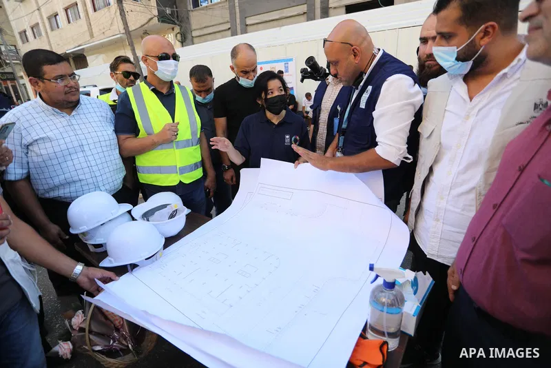 Palestinian workers use a bulldozer to remove the rubbles of al-Jawhara tower which was hit by Israeli strikes during the recent 11-day conflict between Israel and Hamas on May, in Gaza city on September 26, 2021. The to...