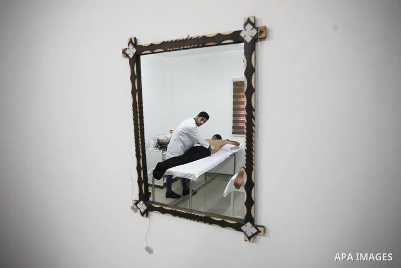 A Palestinian specialist performs Hajima, also knows as "wet cupping therapy", on a patient in Khan Younis in the southern of Gaza strip on September 26, 2021. Hijama is considered a traditional medical treatment in Isla...