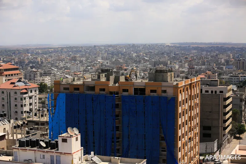 Palestinian workers use a bulldozer to remove the rubbles of al-Jawhara tower which was hit by Israeli strikes during the recent 11-day conflict between Israel and Hamas on May, in Gaza city on September 27, 2021. The to...