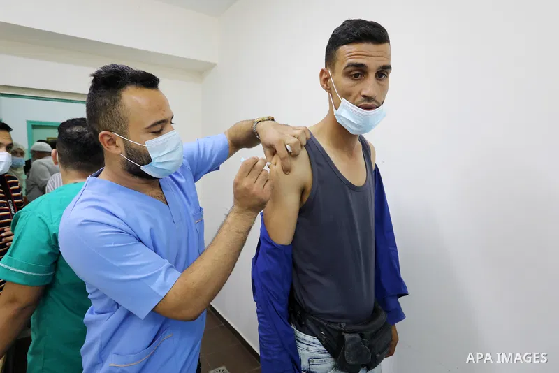 Palestinians get inoculated with a dose of the Covishield vaccine against the Covid-19 coronavirus, at a temporary vaccination centre set up, in Deir al-Balah in the center of Gaza Strip on September 28, 2021. Photo by A...