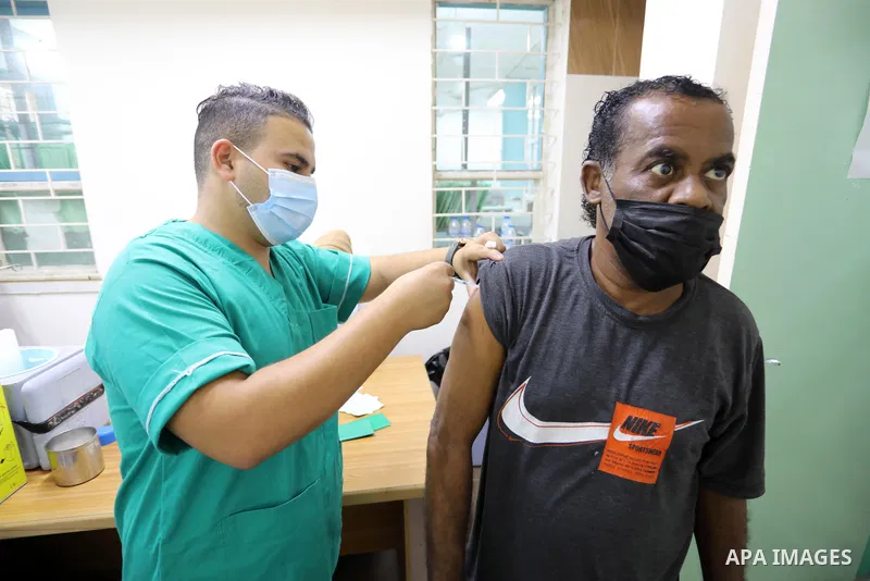 Palestinians get inoculated with a dose of the Covishield vaccine against the Covid-19 coronavirus, at a temporary vaccination centre set up, in Deir al-Balah in the center of Gaza Strip on September 28, 2021. Photo by A...