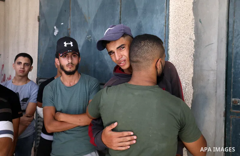 Relatives of Palestinian fisherman Mohammad Abu Ammar, 40, who was killed by Israeli fire, while fishing, mourn at a morgue, in the center of Gaza strip, on September 30, 2021. Photo by Ashraf Amra