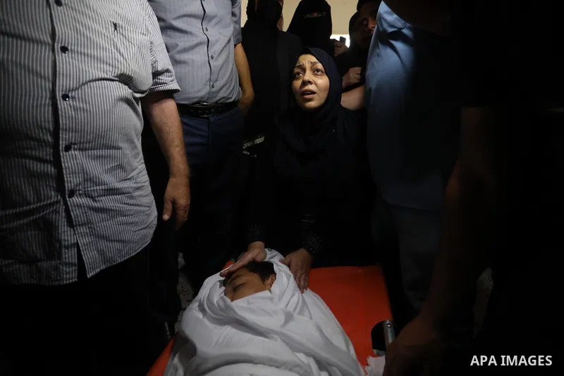 The mother of Palestinian teen Omar Abu Neal, 12, mourns over his body during his funeral in Gaza city on August 28, 2021. Abu Neal is the second Palestinian to die of wounds sustained during the same activity held marki...