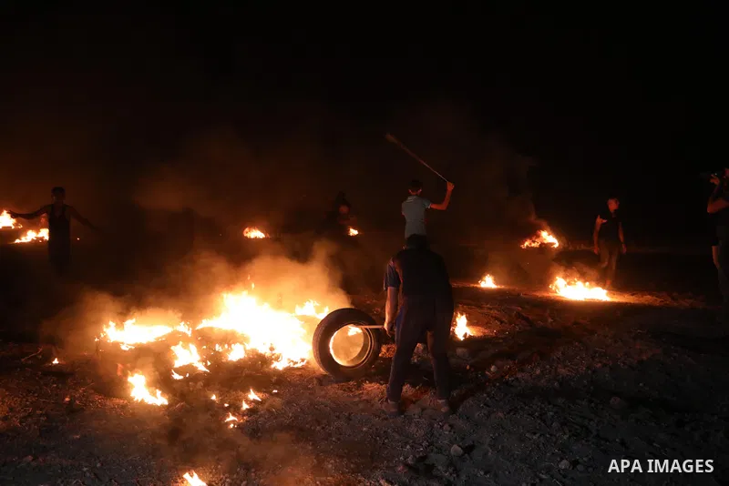 Members of Palestinian protesters calling themselves the "night confusion units", burns tires as they gather near the Gaza-Israel border east of Gaza city, August 28, 2019. Hundreds of Palestinian protesters, have been o...