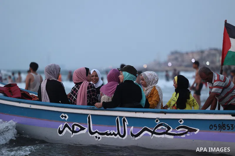 Palestinians gather at the beach in the Mediterranean Sea in Gaza city on August 28, 2021. The beach is one of the few open public spaces in this densely populated city. Photo by Osama Baba